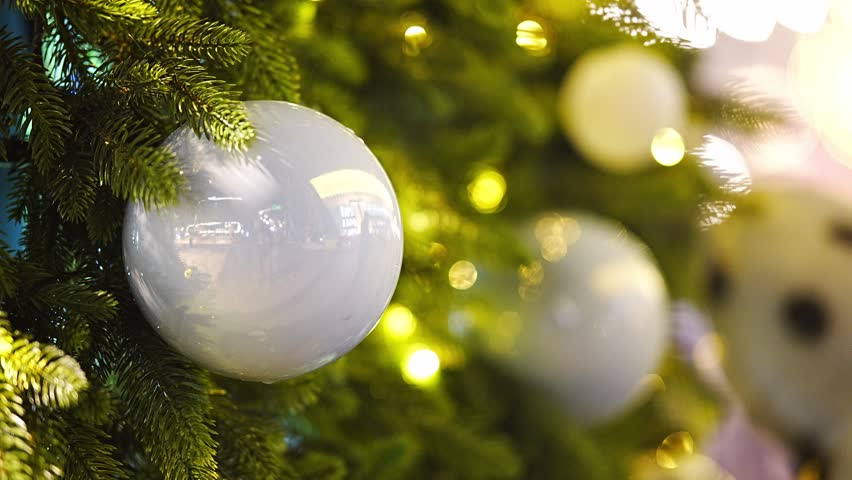 Christmas tree with white and blue ornaments and warm festive lights