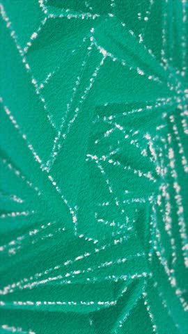 Angular white markings on teal form an abstract close-up.