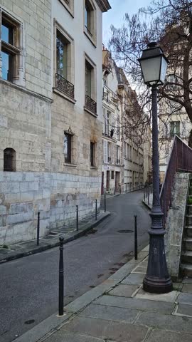 Quiet and historic parisian corner on the ile de la Cite, at the intersection of Rue des Ursins and Rue des Chantres. Reconstructed medieval style buildings with a distinct gothic arched doors