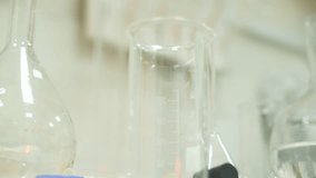 Scientific research laboratory equipped for chemical experiments, featuring glass flasks, beakers, test tubes. Space for innovative studies, analysis, and development of chemical compounds, reactions. - Powered by Shutterstock - Get 15% off with code: PIKWIZARD15