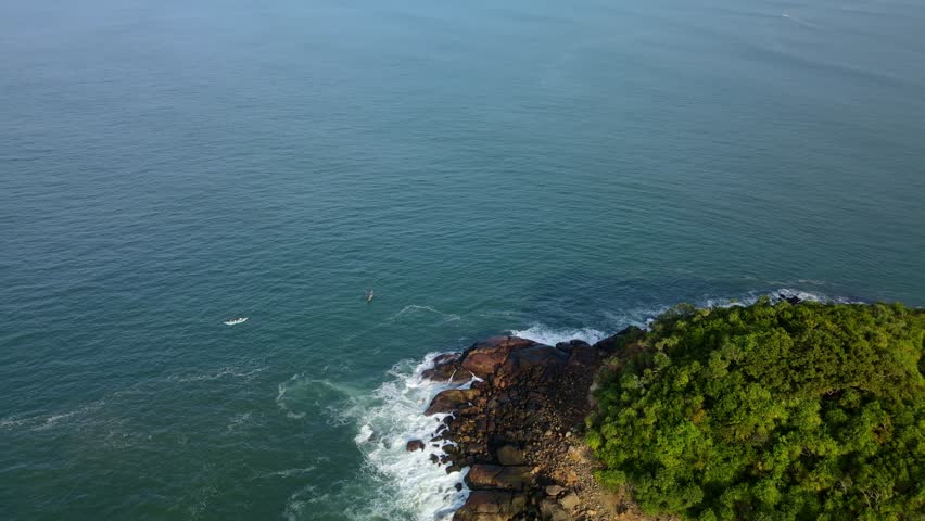 Ocean waves crash against the island