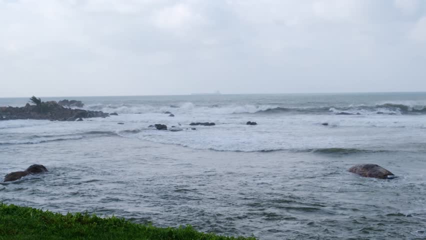Ocean waves crash against the island