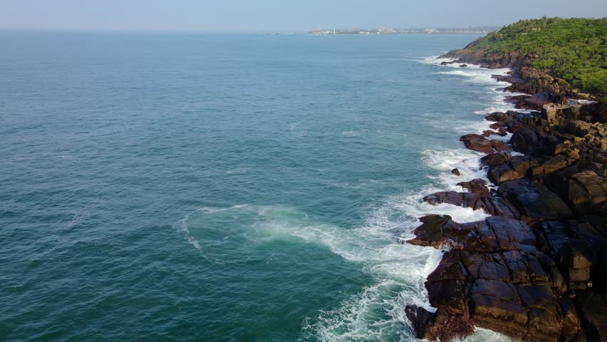 Ocean waves crash against the island
