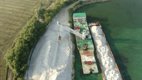 Aerial View of Crane Unloading Sand Barge in Moscow