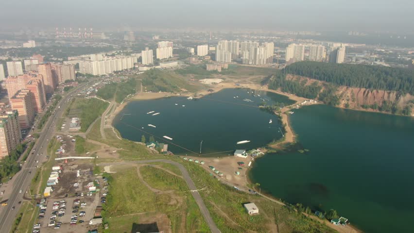 Drone flying forward and tilting down over lake