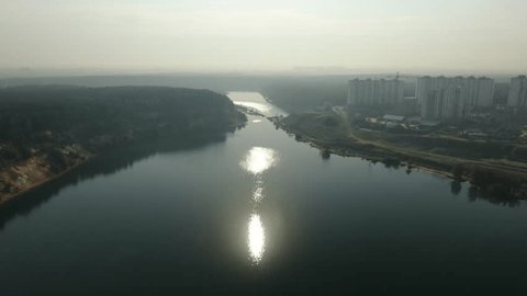 Drone Descending toward Sunlit River Surface