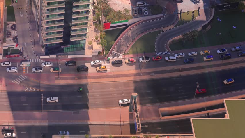 Aerial view of the high-rise city of Dubai on a sunny day. Streets and roads, buildings of the eastern city, public spaces.