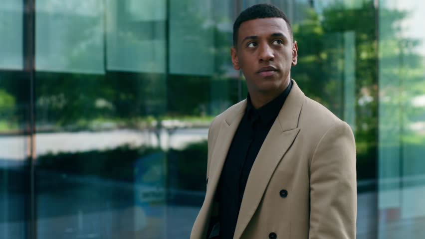 Serious confident African American business man walking city outdoors office building male entrepreneur employer businessman manager investor going work urban focused guy company lifestyle success