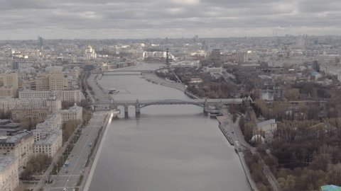 Drone Advancing over River through Cityscape