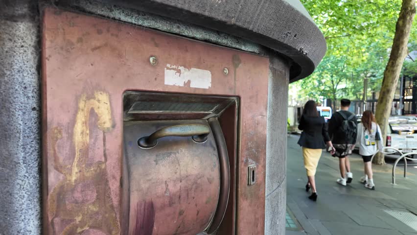 An obsolete bank night safe embedded in the exterior wall of a historic banking building in Melbourne, Australia, with a heavy metal deposit door.