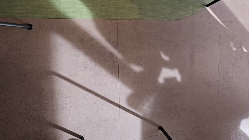 Beautiful indoor shadow shape gentle sunlight, glowing on concrete rock ground texture in the afternoon coffee shop background—dappled light flickering in calm and relaxing atmosphere,cafe interior