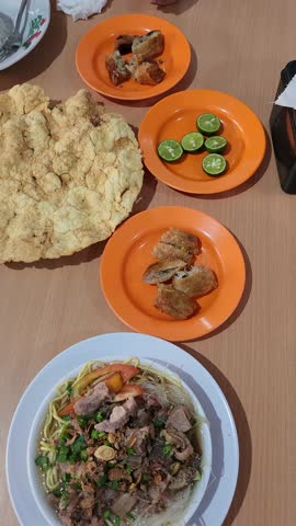Steaming bowl of soto mie with broth, noodles, and savory toppings. Traditional Indonesian noodle soup commonly served as street food and everyday comfort cuisine