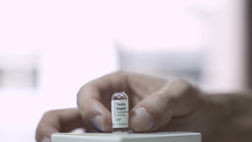 Syringe Drawing Testosterone from Glass Ampoule, Hormone Therapy Concept