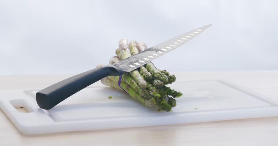 Natural beauty of green asparagus displayed on chopping board.