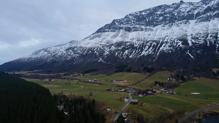 Drone shot of a small town in the mountain in Norway on a bright winter day