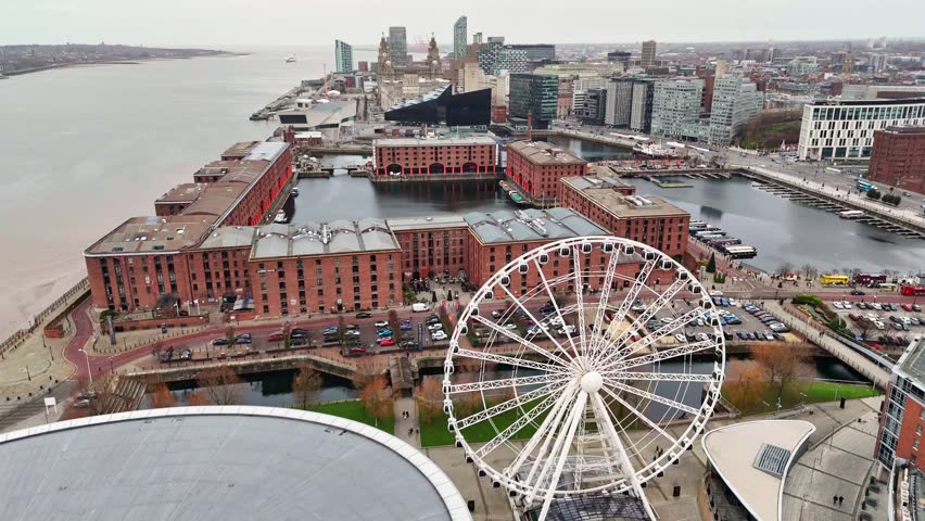 Overlooking the Wheel of Liverpool rotating on the Liverpool waterfront along the banks of the River Mersey.