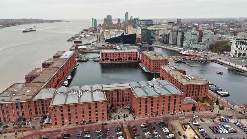 Liverpool cityscape over the Wheel of Liverpool featuring the Royal Albert Dock, the Three Graces, the Metropolitan Cathedral and the Anglican Cathedral.