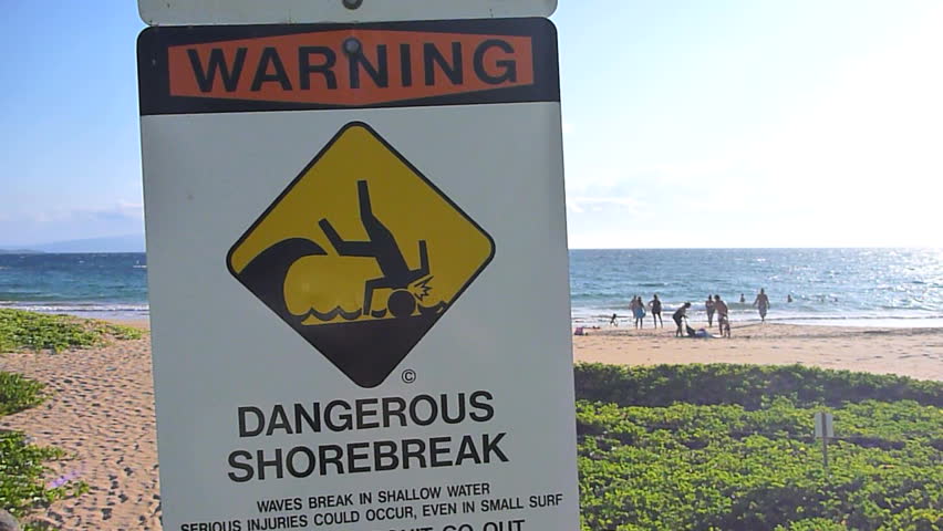 Dangerous shore break sign posted at beach in Hawaii on Maui.
