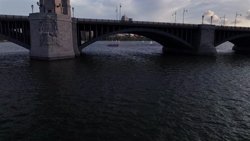 Aerial view of sailboats gliding on the water, contrasting with Boston