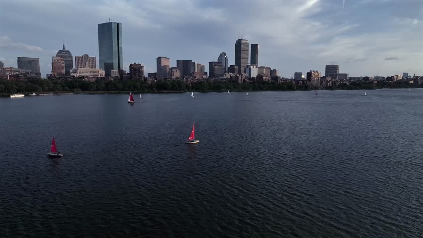Aerial view of sailboats sailing on the Charles River with the Boston skyline featuring the Prudential Tower and the John Hancock Tower in the background, Boston, Massachusetts, United States.