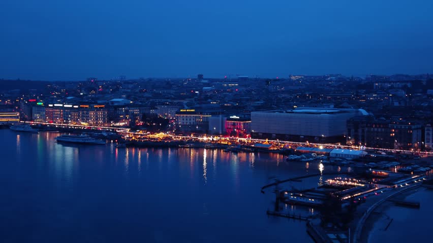 Aerial view of Quai du Mont-Blanc at night, a picturesque scene with lights reflecting on the water, Geneve, Switzerland.