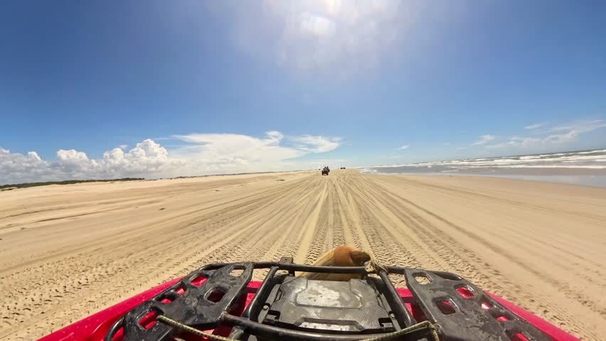 POV riding an ATV quad bike in a group excursion across Lencois Maranhenses dunes brazil