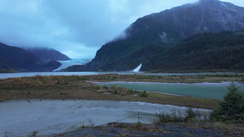 Gimbal wide panning shot of the awe-inspiring Mendenhall Glacier and Nugget Falls in the evening at Alaska