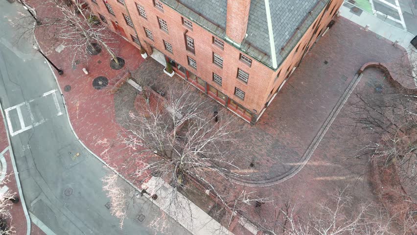 Aerial view of the brick building and road with bare trees creating a stark contrast against the urban landscape, Boston, Massachusetts, United States.