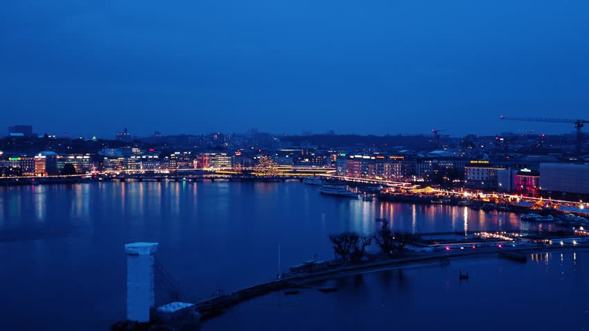 Aerial view of Quai du Mont-Blanc at night, its lights reflecting on the water in an amazing display of colors, Geneve, Geneve, Switzerland.