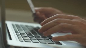 Close-up of a man paying for online shopping with a laptop and credit card, illustrating digital commerce, e-payment, and secure transactions. - Powered by Shutterstock - Get 15% off with code: PIKWIZARD15