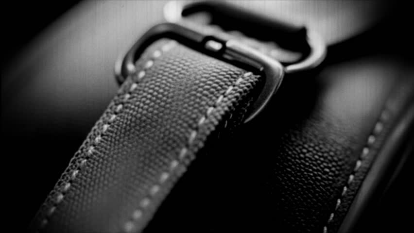 A close-up view of a watch strap in black and white.. Retro video.