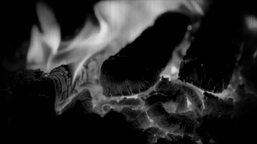 A close-up shot of a burning fire in black and white, ideal for use in editorial or commercial contexts.. Retro video.