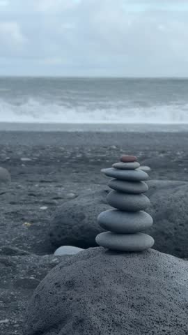 Close-Up Balanced Rock Cairn on Volcanic Pebble Shore in Iceland. High quality FullHD footage