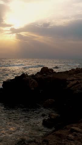 Dawn, sunrise over the sea. beautiful seascape, rocky coast and foaming waves of the sea surf