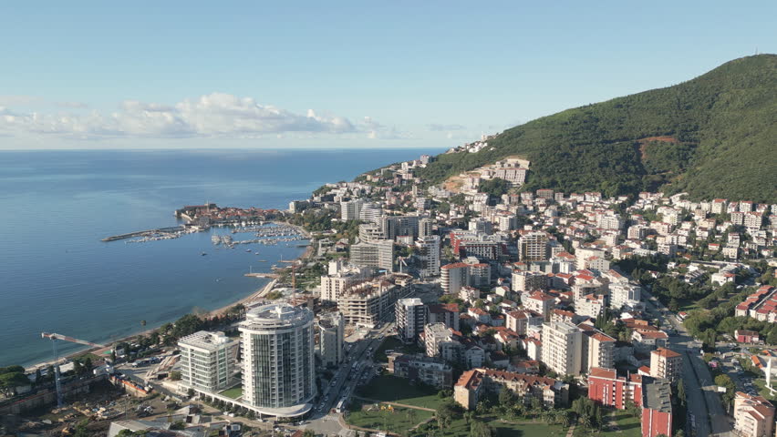 Aerial footage of sunny panorama of Budva, a coastal city nestled on the Adriatic shore in southern Montenegro.