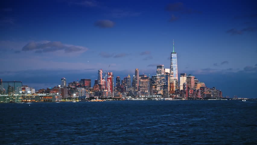 Spectacular skyline of New York downtown from the riverscape. Dazzling view of Manhattan at dusk time.