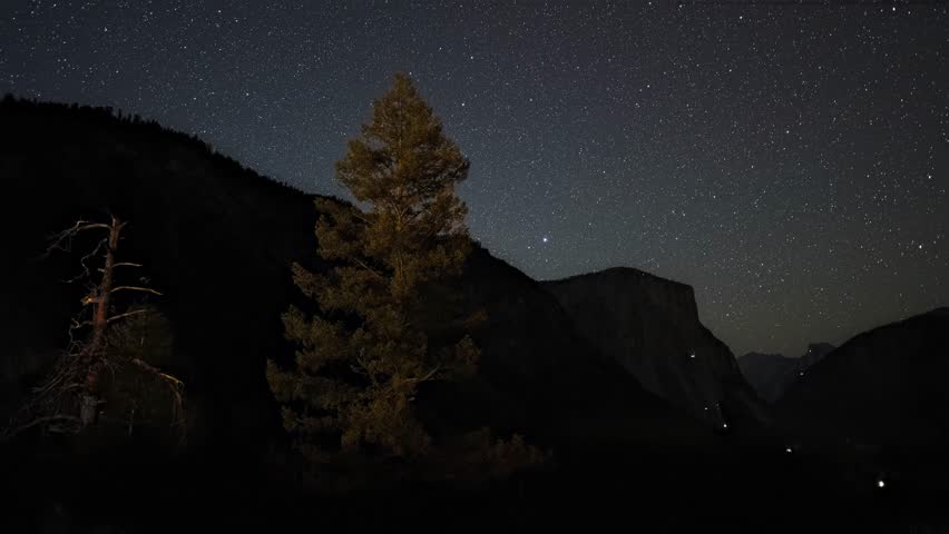 4K horizontal time-lapse video taken at Tunnel View in Yosemite National Park at night. Half Dome and El Capitan frame Yosemite Valley below as the Milky Way rises in a starry sky. The camera slowly pans from left to right, creating a cinematic and awe-inspiring nighttime landscape.