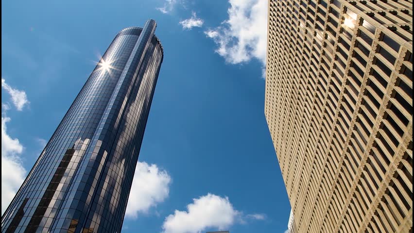 Timelapse of clouds looking up at skyscraper