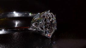 Brilliant Diamond Silver Ring Shines in Dramatic Macro Close-Up. Revealing Its Sparkling Facets Refined Metalwork. Luxurious Blend of Artistry, Elegance and Timeless Beauty In Every Glowing Detail 4k - Powered by Shutterstock - Get 15% off with code: PIKWIZARD15