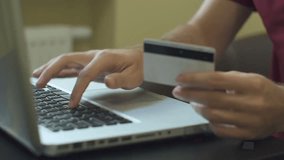 Close-up of a man paying for online shopping using a laptop and credit card, demonstrating secure digital payments and e-commerce transactions. - Powered by Shutterstock - Get 15% off with code: PIKWIZARD15