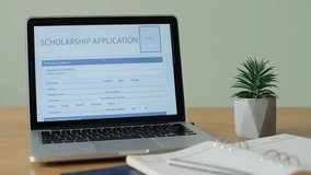 Laptop computer displaying a scholarship application form on screen, online education, student application process, and digital learning concept. - Powered by Shutterstock - Get 15% off with code: PIKWIZARD15