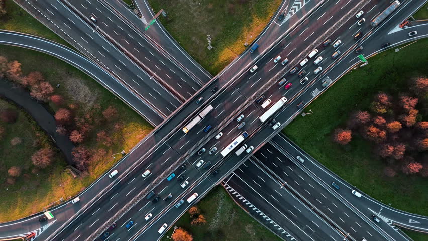 Aerial view of busy highway intersection during autumn at sunset