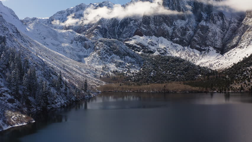 Pannig across Convict Lake in the Sierra Nevada, featuring the jagged peaks of Mount Morrison within the Sherwin Range and the vibrant alpine shoreline of Mono County, California, USA