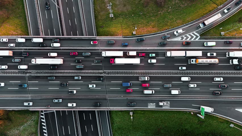 Aerial view of busy highway with vibrant vehicles and lush greenery