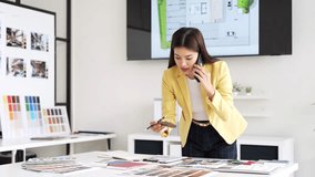 Designer working in office and making call on mobile phone. - Powered by Shutterstock - Get 15% off with code: PIKWIZARD15