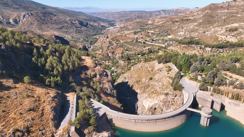 Flight across the dam walls and dramatic ravine drop of Granada