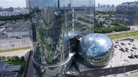 Aerial Takeoff beside Modern Office Towers