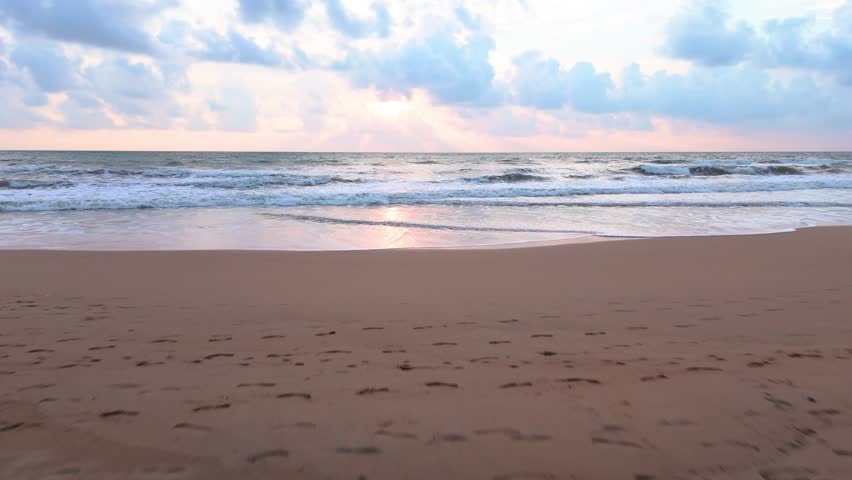 Fly over beach out over the sea during sunset, Bentota beach, Sri Lanka