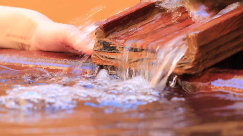 Japanese woman feeling the warmth of the hot spring water
