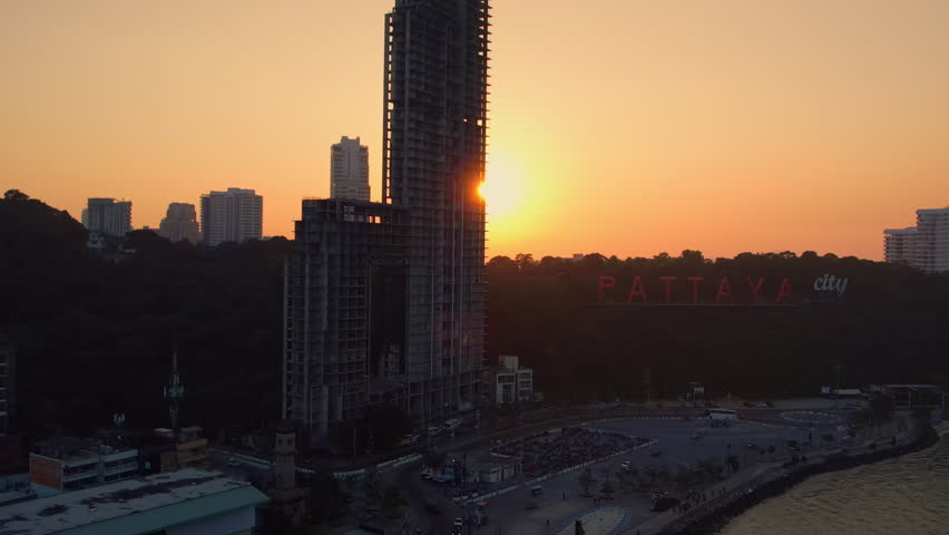 Fly up abandoned tower next to Pattaya City sign